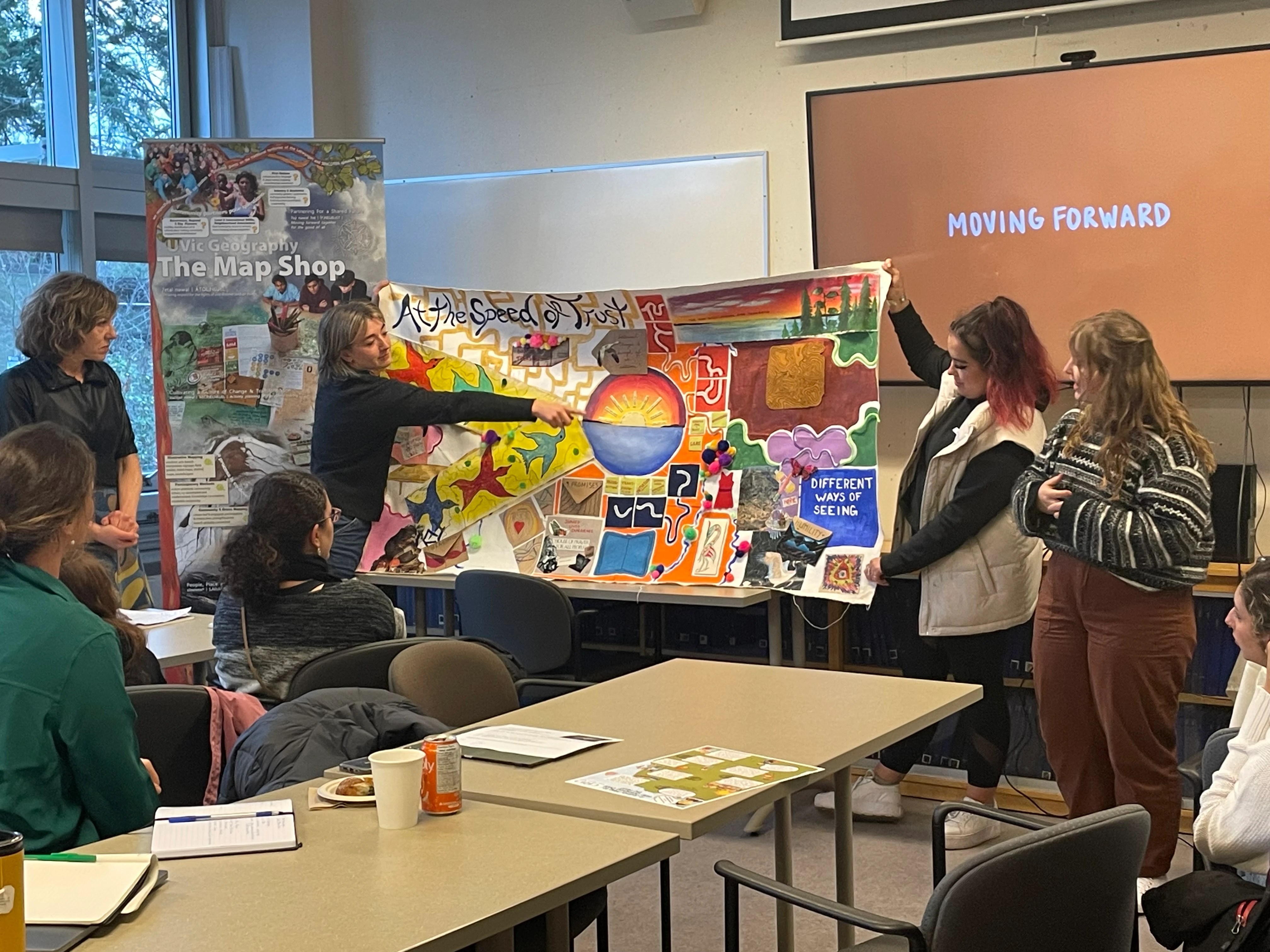 Students students presenting their final project for GEOG 411, "Co-Creating Research for Sustainable Futures".