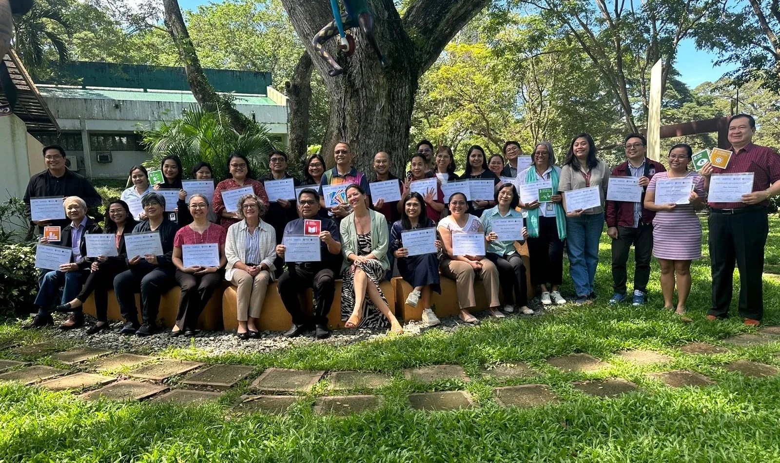 Executives from the University of the Philipines pose with their Certificates of Completion from CIFAL Victoria for participating in the "Developing a Sustainability Mindset" course.